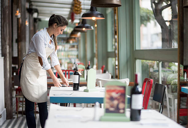 Waitress setting tables at a restaurant Waitress setting tables at a restaurant
